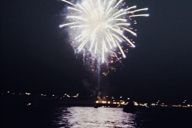 fireworks in the sky over a body of water